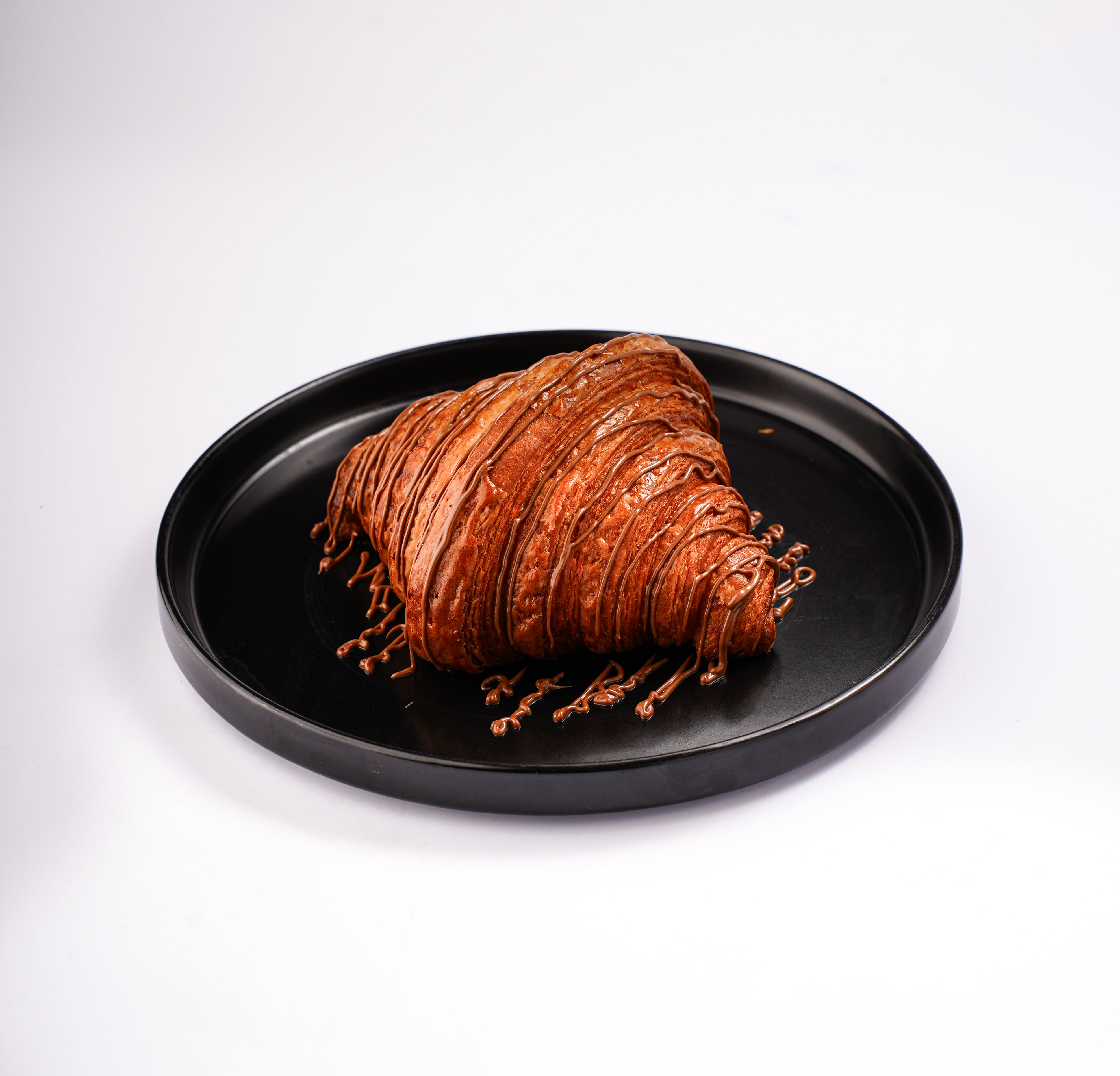 Chocolate croissant with rich filling freshly baked at The Croissant Guy Karachi bakery