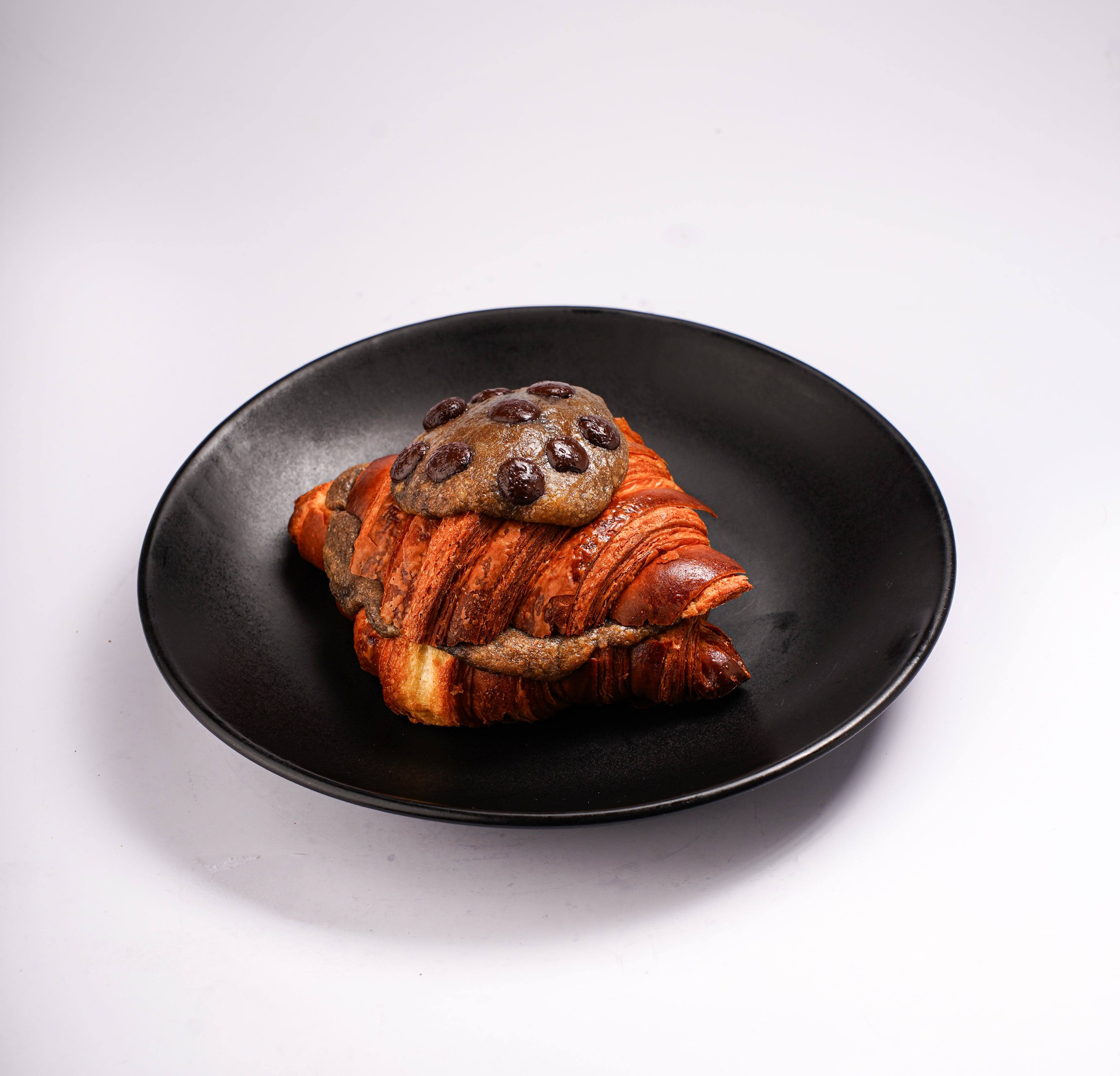 Cookie dough croissant topped with chocolate cookie dough at The Croissant Guy Karachi